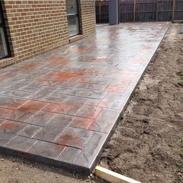 Newly finished concrete path with slate impression